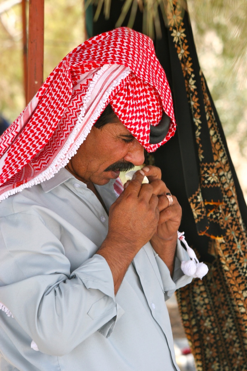 a Bedouin man tasting jameed - Jordan tour