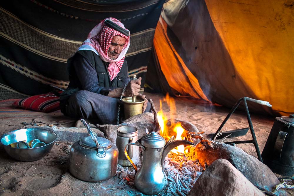Bedouin man in Wadi Rum grinding coffee - Jordan tour
