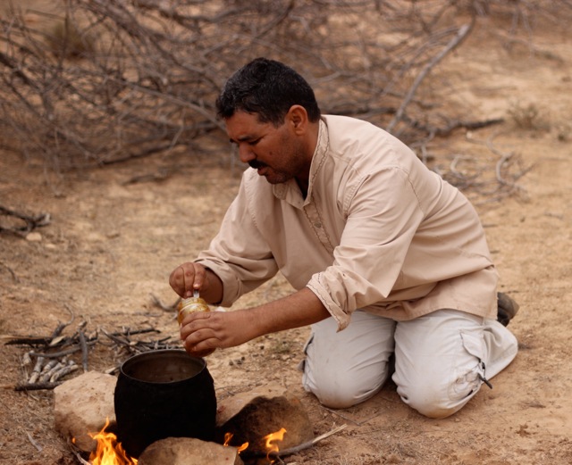 Building a fire for a traditional Berber lunch near Chenini Tunisia