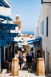 People walk to and from local shops near Bab il Gharbi in the Sousse Medina Tunisia