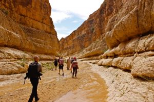 Travellers hiking in Mides canyon in southern Tunisia