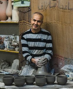 Potter Turns Clay on wheel in Nabeul Tunisia