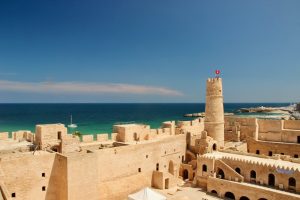 The Monastir Ribat (Islamic fortress) with turquoise waters of the Mediterranean Sea in the background