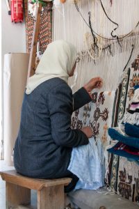 Weaver working at a loom in Kairouan